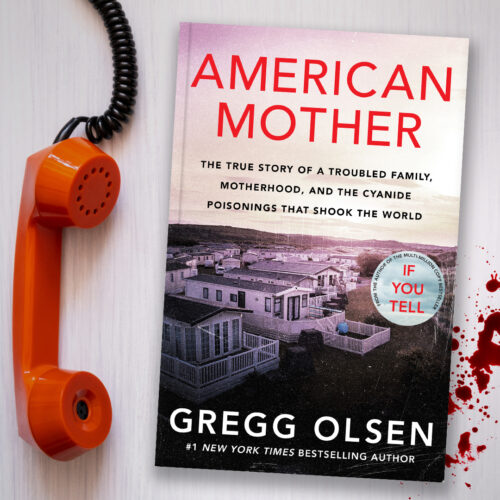 American Mother book sits on a white table next to an old fashioned red phone and a splatter of blood.