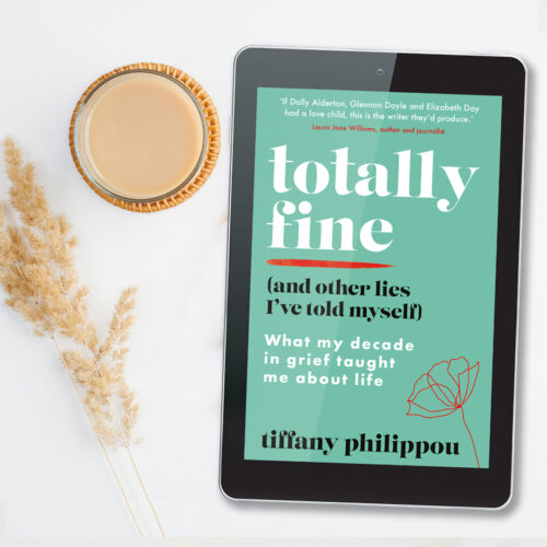 An ebook showing the cover of Totally Fine, sitting on a white background with a cup of coffee and dried flowers